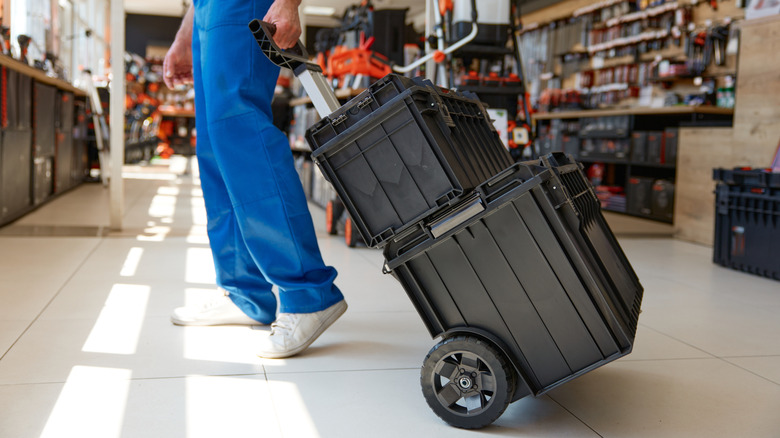 A man pulling a rolling tool box