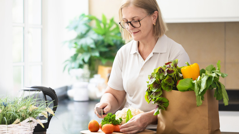 Woman chopping vegetables in kitchen