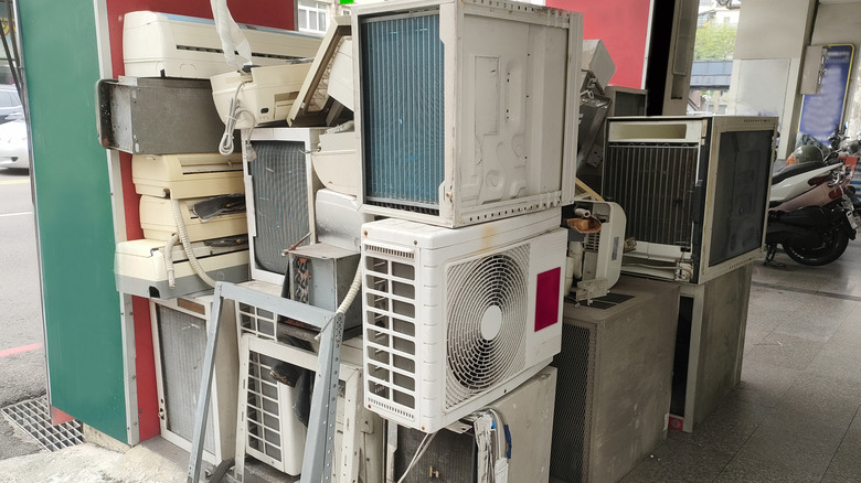 A stacked pile of ac units and parts.
