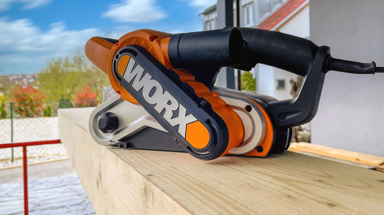 A Worx tool sitting atop a piece of wood