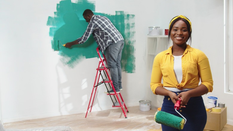 Couple painting a room