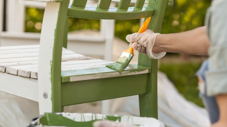 Someone painting a chair