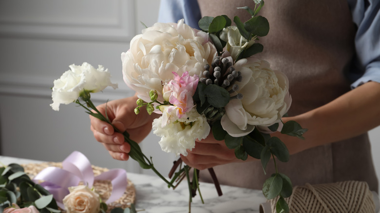 person arranging flowers