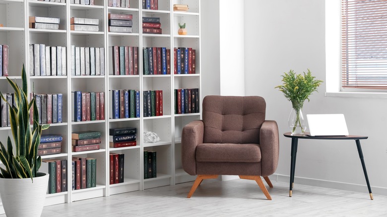 armchair in room with bookcase