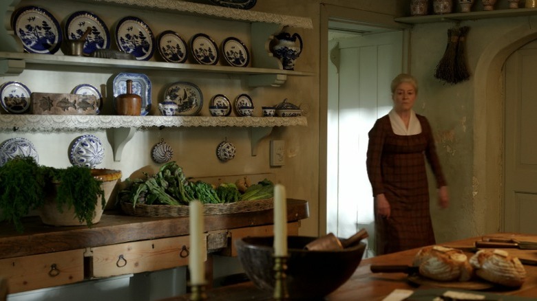 Ms. Crabtree walks into a decorated kitch in the servants quarters at "My Cottage"