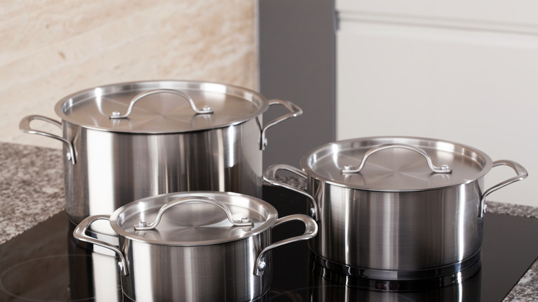 Clean disposable aluminum pie pans on a table.