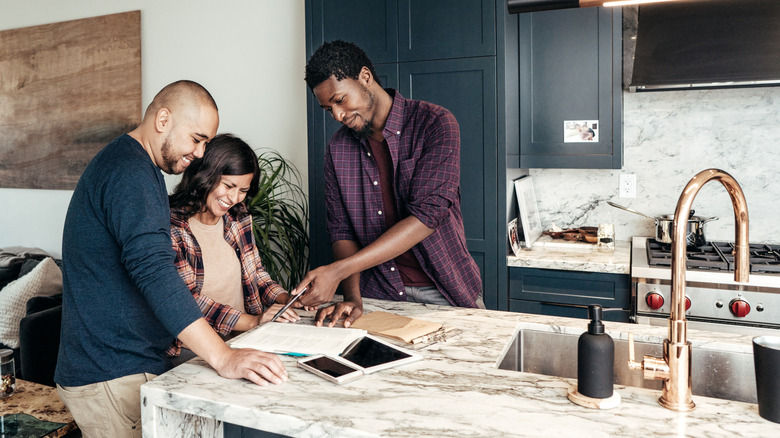 couple and contractor in kitchen