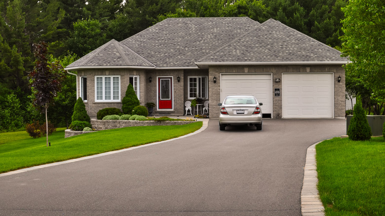 home with car parked on asphalt driveway