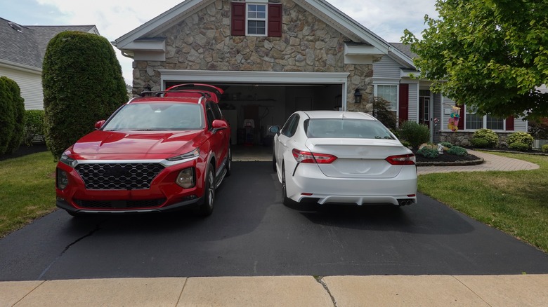 driveway with red and white cars