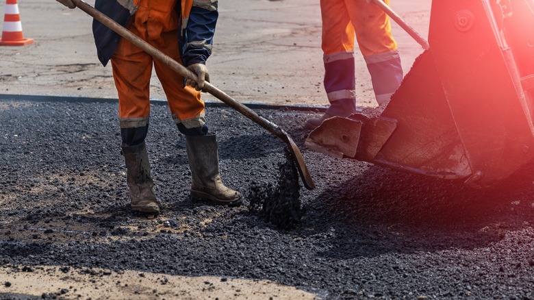 workers spreading asphalt