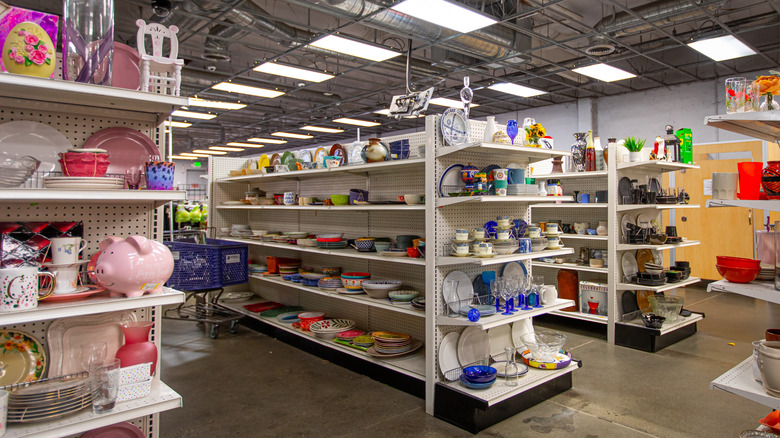 Inside a thrift store with dishware on shelves