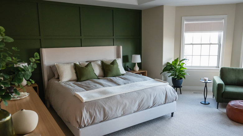 Bedroom with green accent wall and green furniture