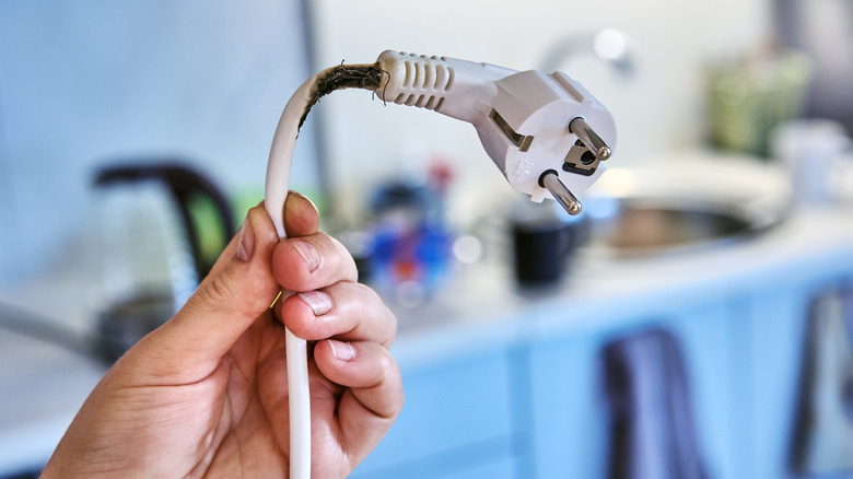 Close up photo of a burnt out grey extension cord