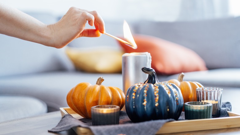 Woman's hand lighting candle