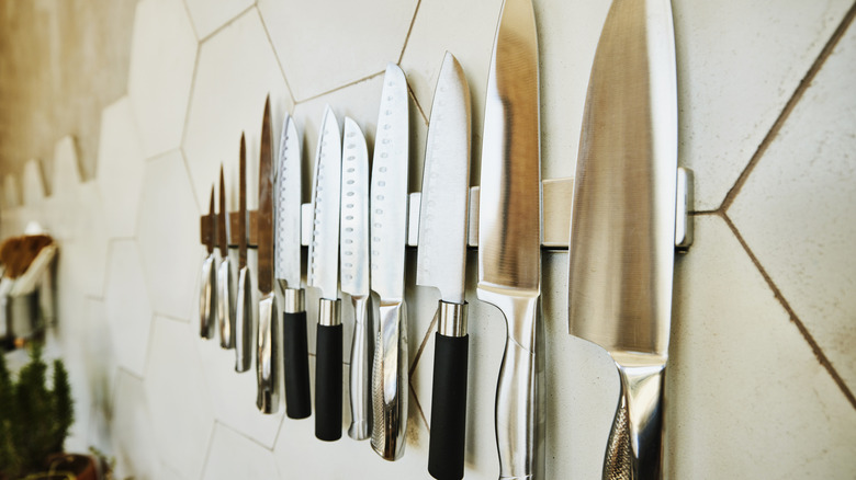 Kitchen knives hanging on a magnetic wall strip