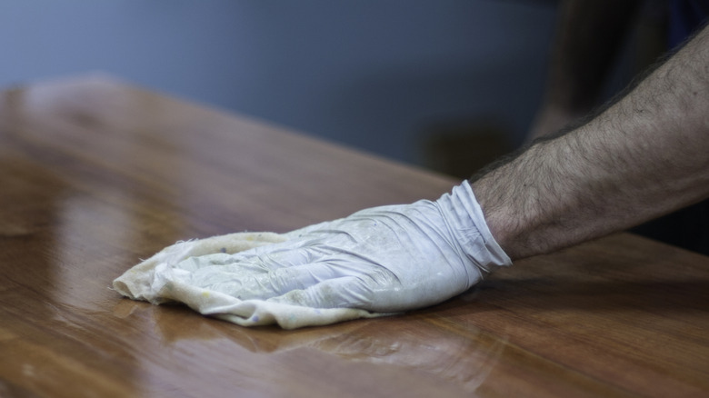 Hand waxing a wooden table