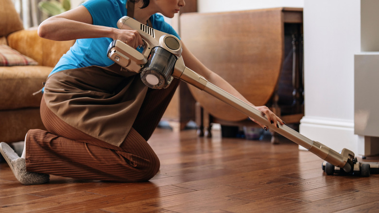 A person cleans a wood floor
