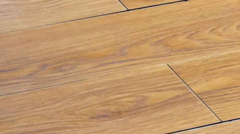 A wood floor shows signs of slight warping
