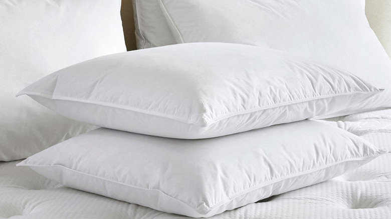 Closeup of a stack of white pillows on a mattress