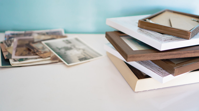 A stack of photos with cheap picture frames.