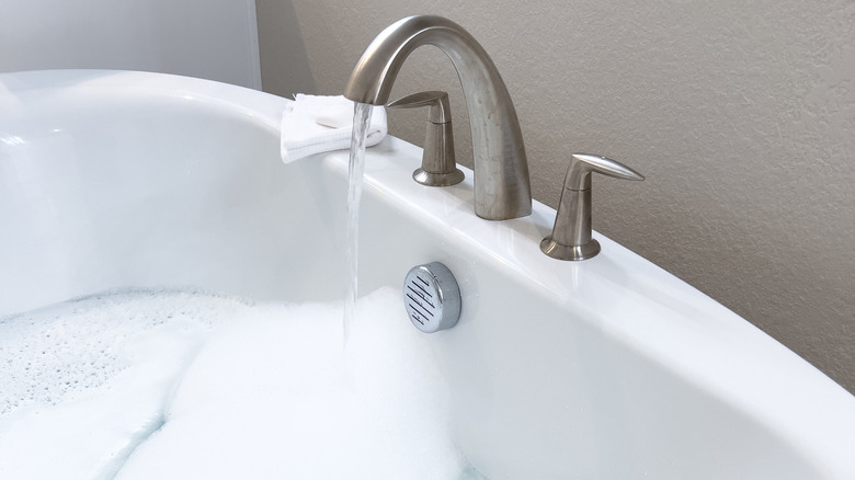 White bathtub with brushed nickel faucet