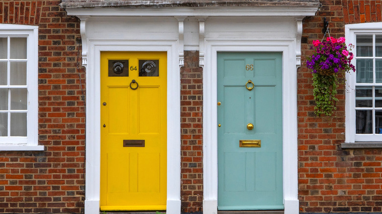 Colorful yellow and blue front doors on a brick exterior