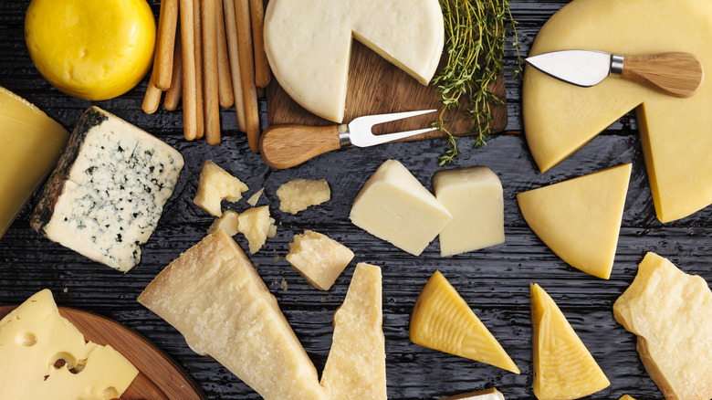 Table filled with a variety of different cheeses