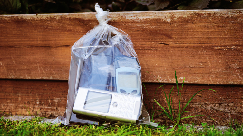 Clear plastic bag of newer and older cellphones