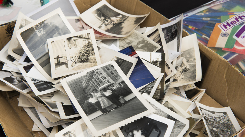 A box full of vintage black and white photographs