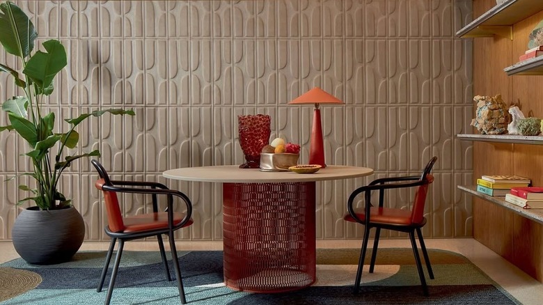 A modern dining space with textured wallpaper.