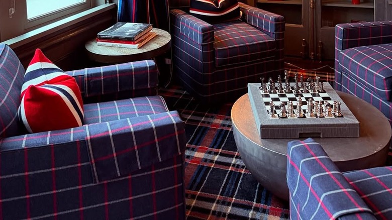 Four plaid chairs on a plaid rug.