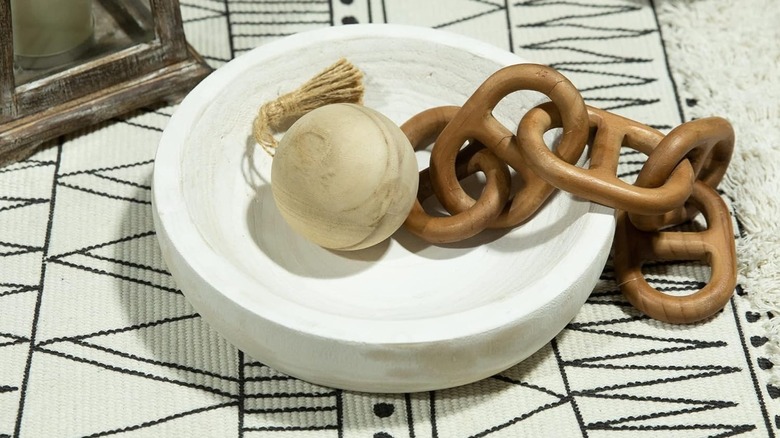 Small white trinket bowl with decorative wood chain and sphere