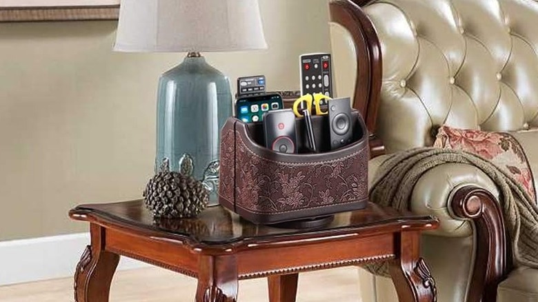 Traditional side table setup with ornate leather remote control organizer and lamp