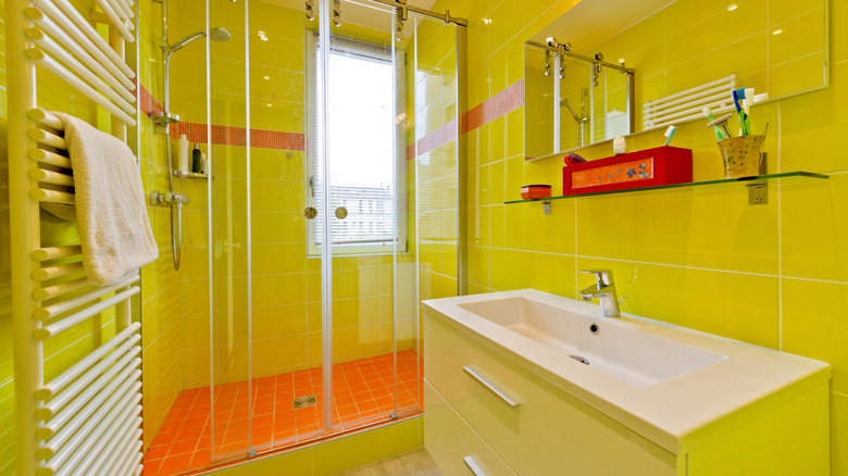 Modern style interior design of a bathroom with bright yellow tiles
