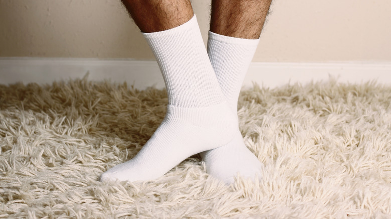 man's feet on shag rug