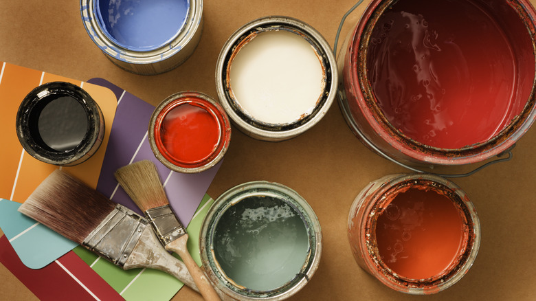 seven open paint cans