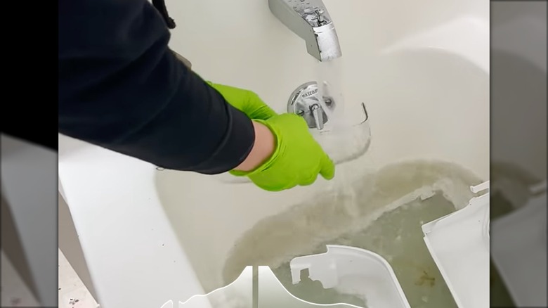 washing refrigerator shelves in a bathtub