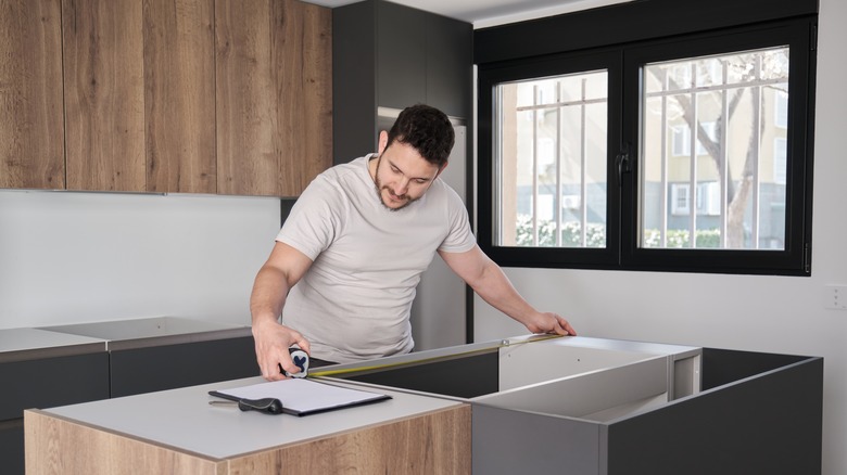 man measuring for countertops