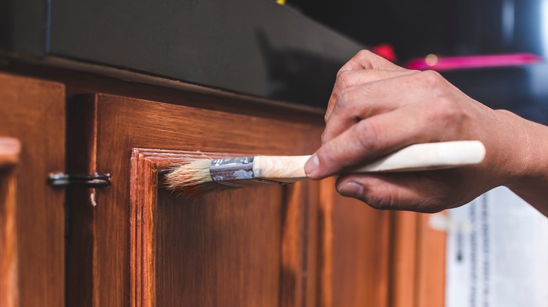 Someone painting cabinets