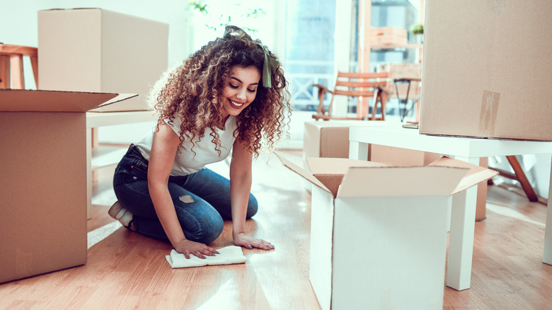 Woman scrubs laminate floors