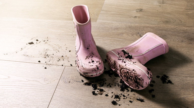 Muddy pink boots on floor
