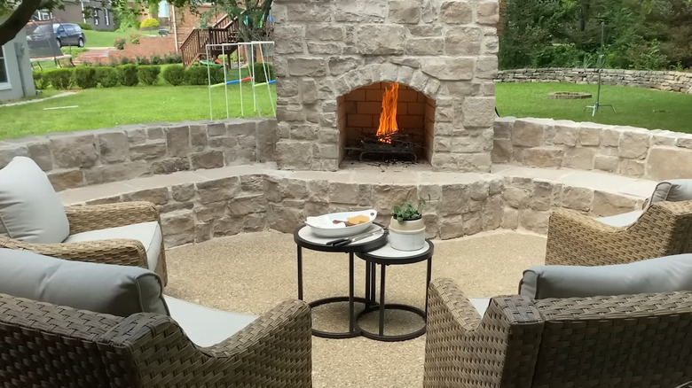 a backyard fireplace with seating