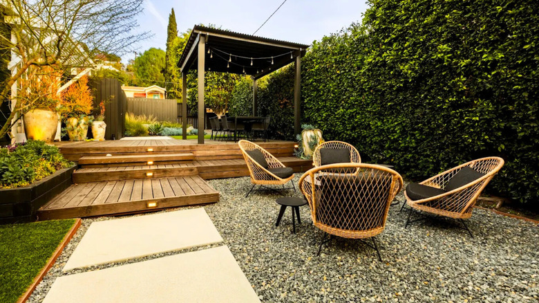 A gravel seating area next to a covered deck