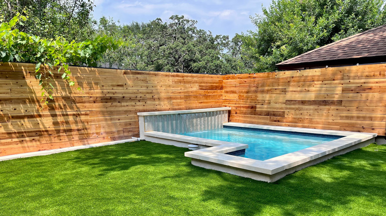 A plunge pool in the corner of a backyard