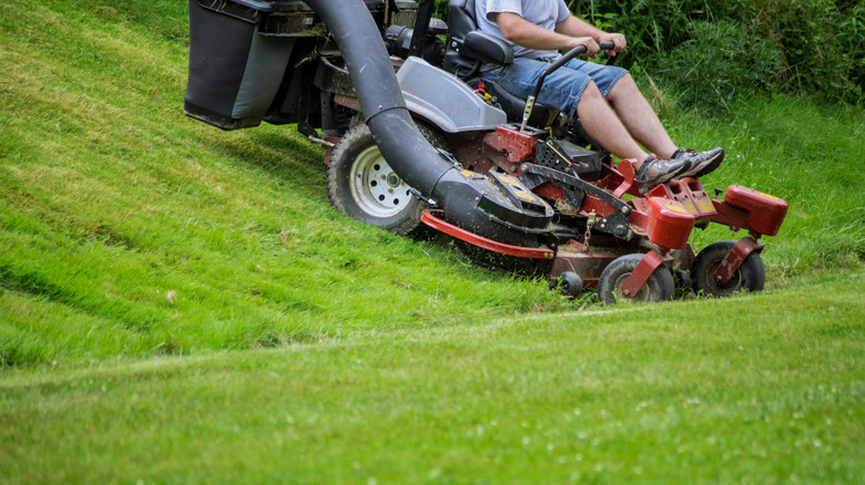 A riding mower coming down a hilly area