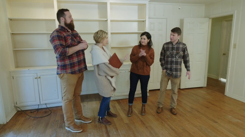 Erin and Ben Napier talking to two clients.