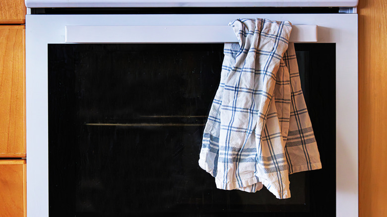Kitchen towel hanging on oven bar