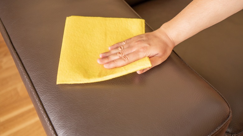Woman cleaning a leather sofa