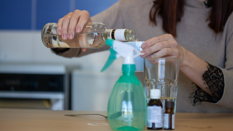Person preparing a linen spray