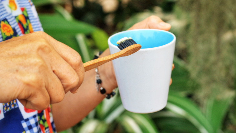 woman holding toothbrush in garden